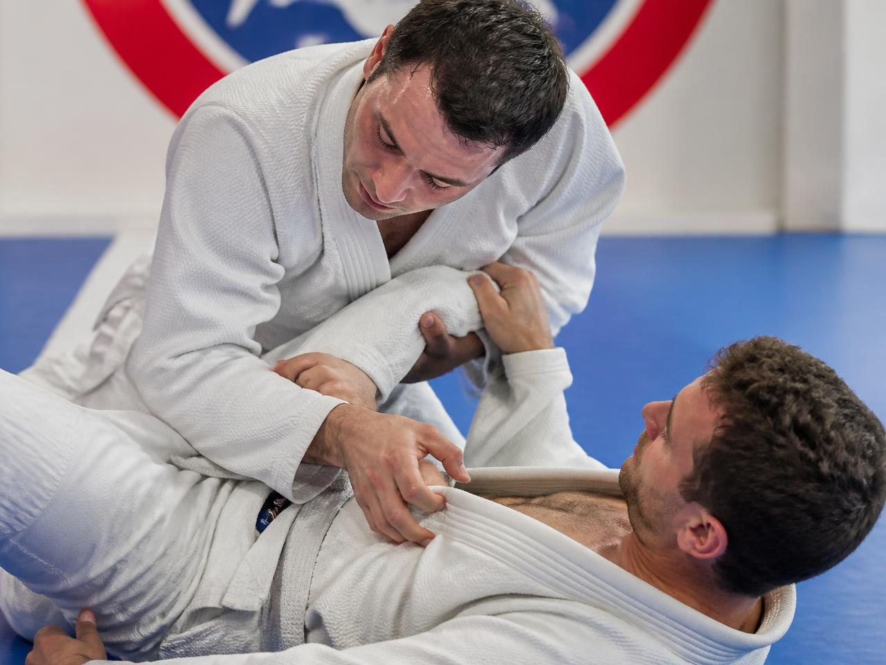Two adult white belts drilling an escape together