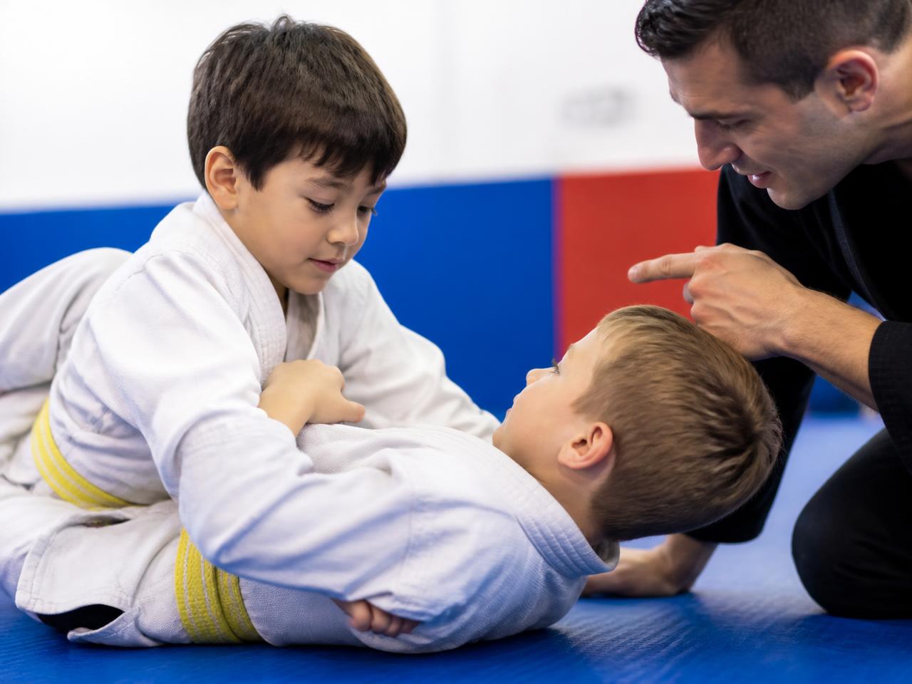 Two yellow-belt kids in a coached positional round